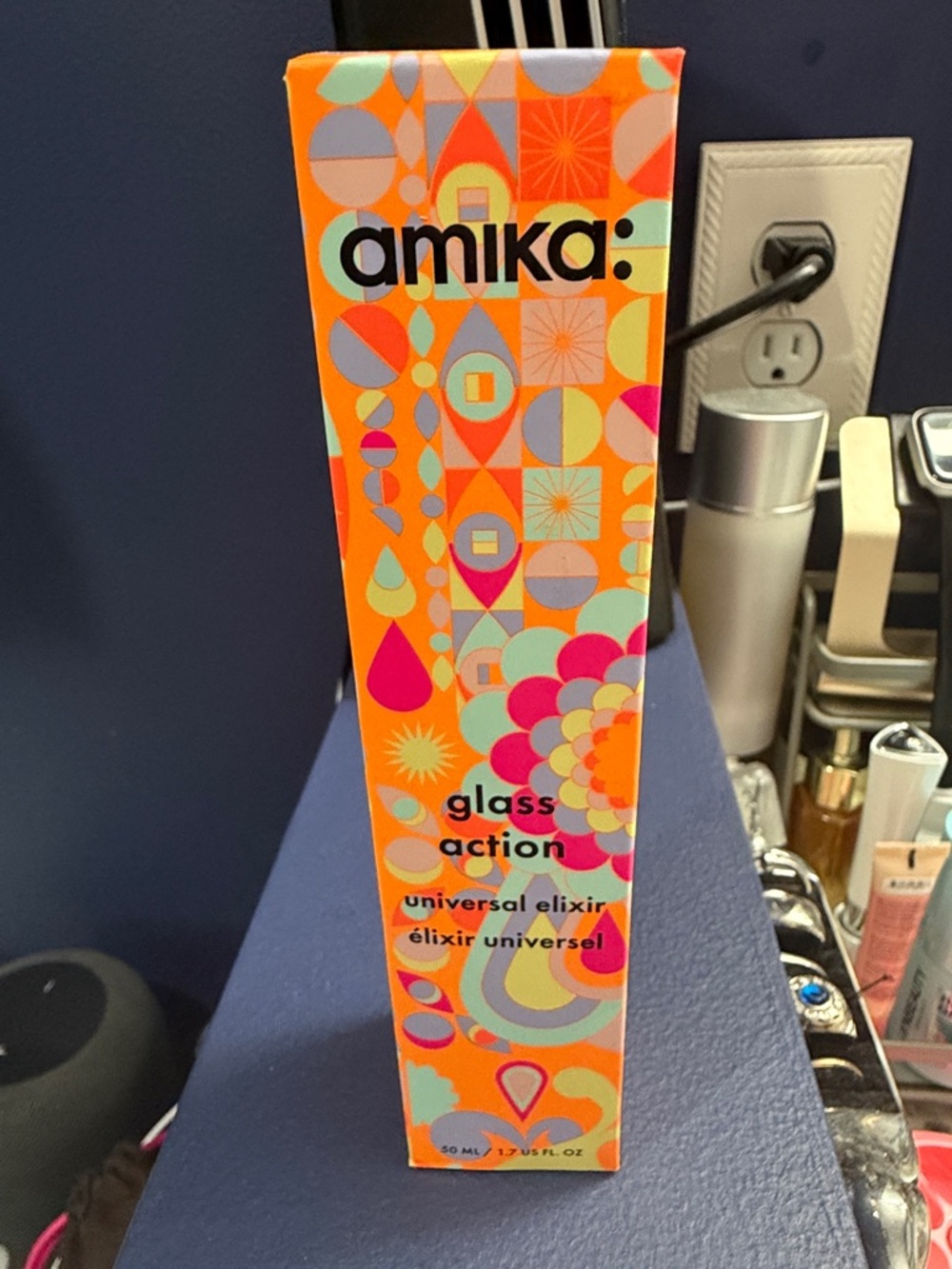 amika Bright Orange Geometric Patterned Hair Elixir Box